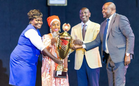 A file photo of President William Ruto presenting a trophy to winners during the National Music Festival Concert.